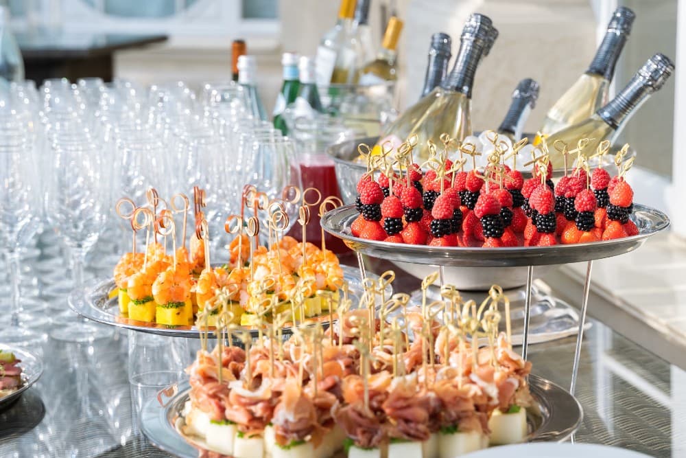 Champagne, fruit, and canapés on a wedding spread